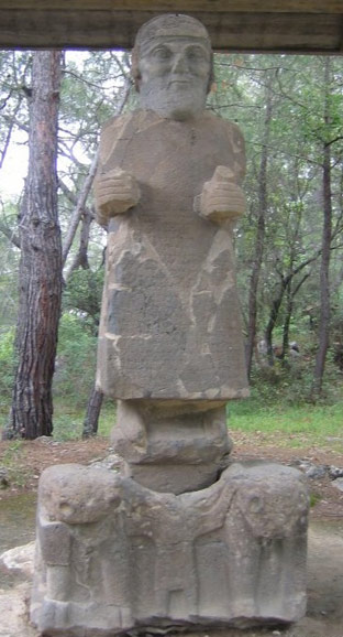 Monumental statue of the storm god of Que standing on his chariot